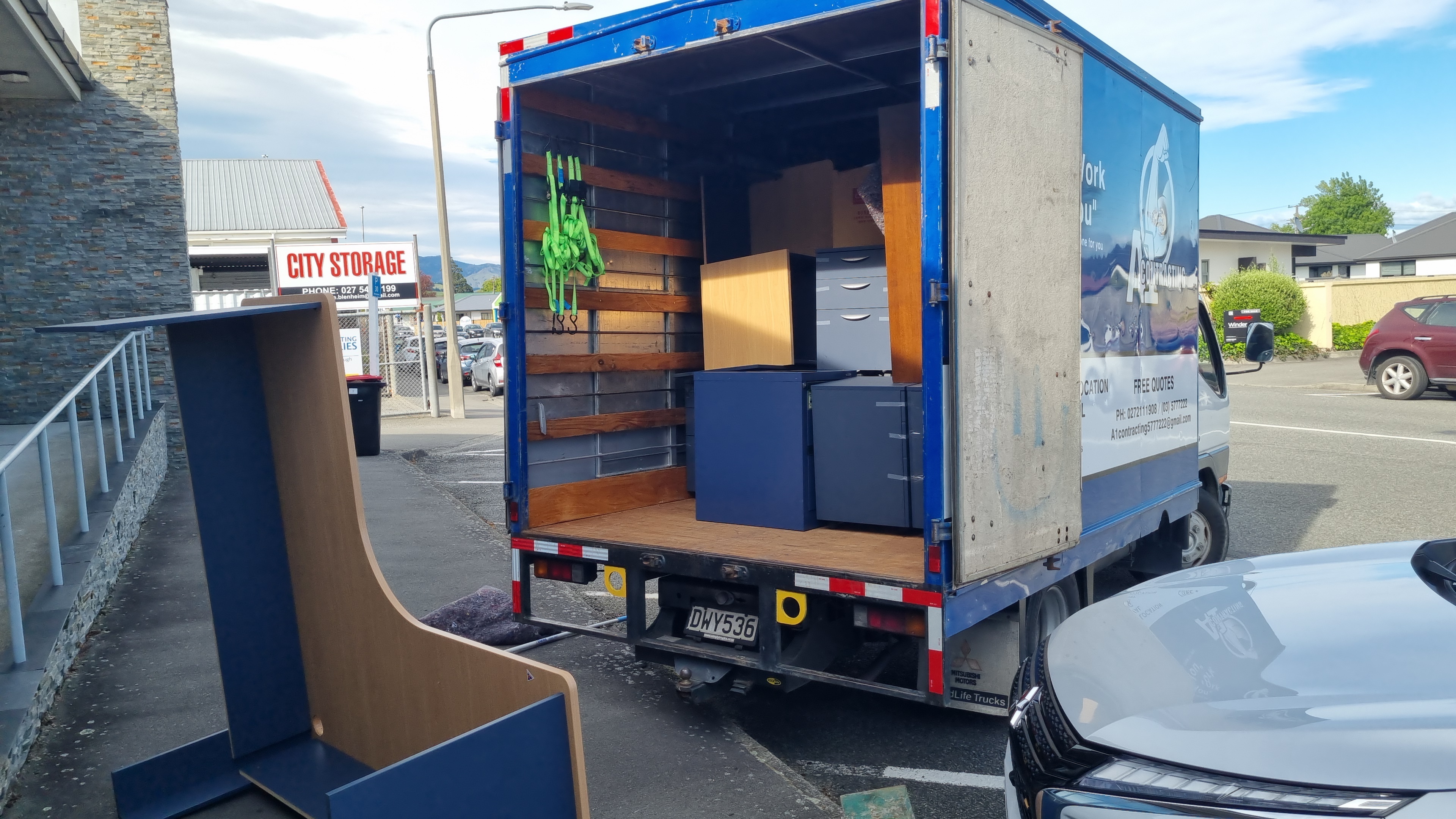 A1 Contracting moving truck loaded in Blenheim commercial area